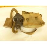A WORLD WAR II GAS MASK AND BAG DATED 1939