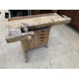 A VINTAGE WOODEN WORK BENCH WITH VICE AND FIVE DRAWERS, BEARING THE STAMP 'RJHBERGS' (SOME WOODWORM)