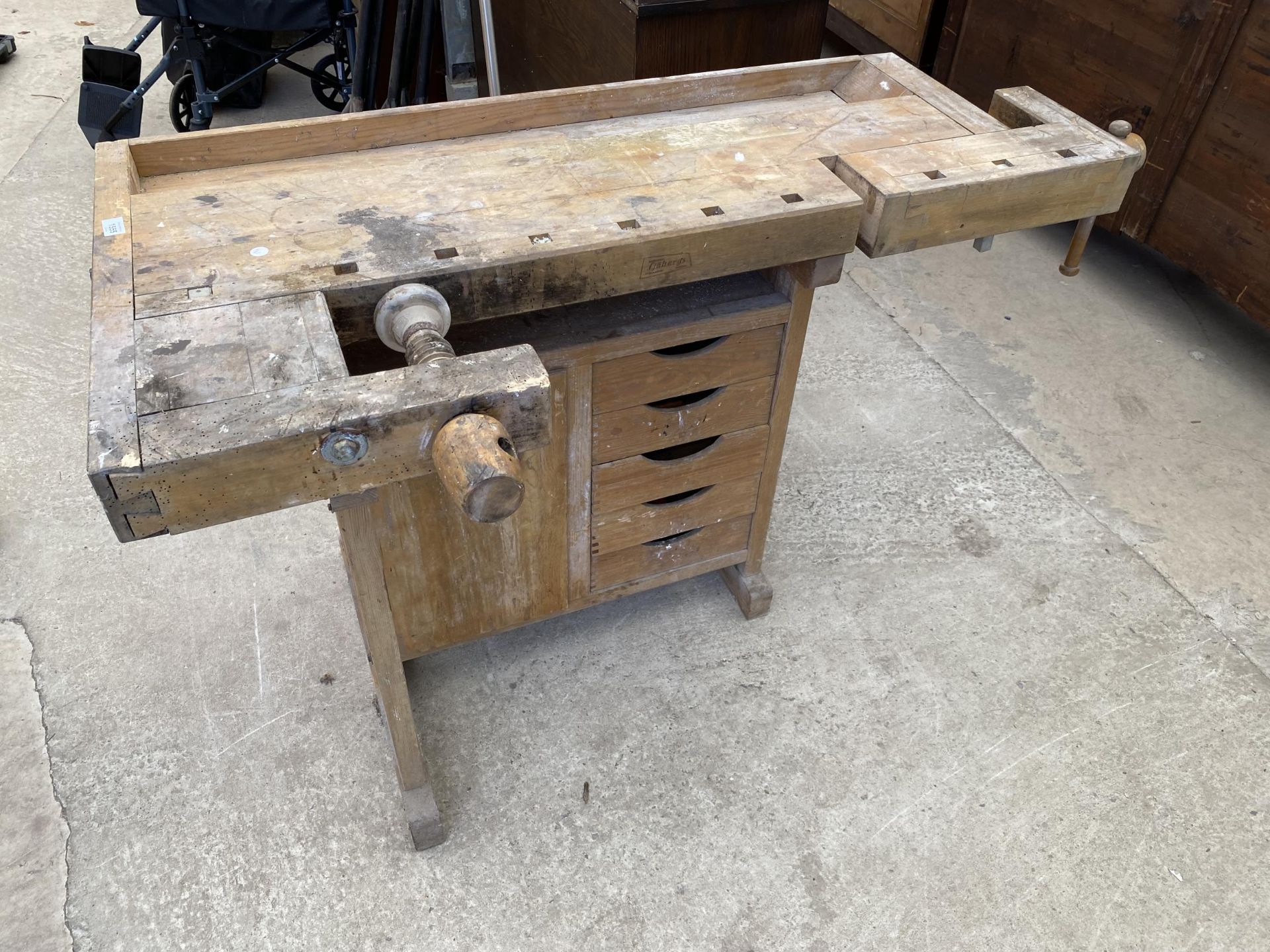 A VINTAGE WOODEN WORK BENCH WITH VICE AND FIVE DRAWERS, BEARING THE STAMP 'RJHBERGS' (SOME WOODWORM)