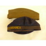 A WORLD WAR II INFANTRY FORAGE CAP DATED 1940 AND A CIA TRASMEDITERRANEA NAVAL CAP (2)