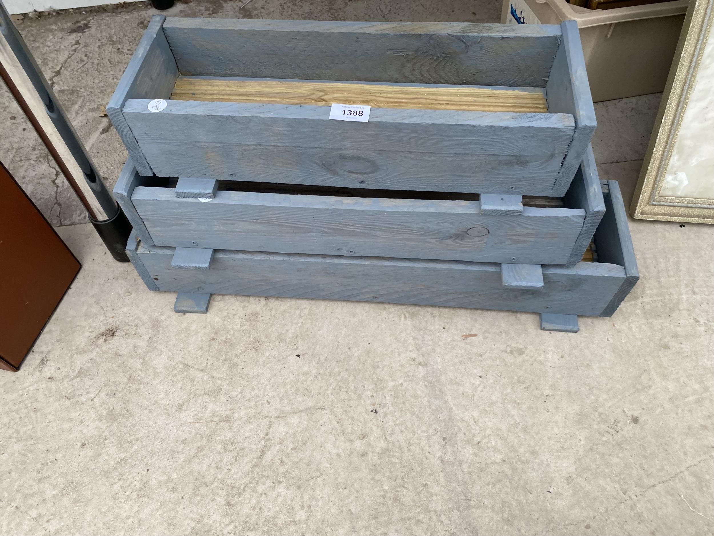 THREE GRADUATED WOODEN TROUGH PLANTERS