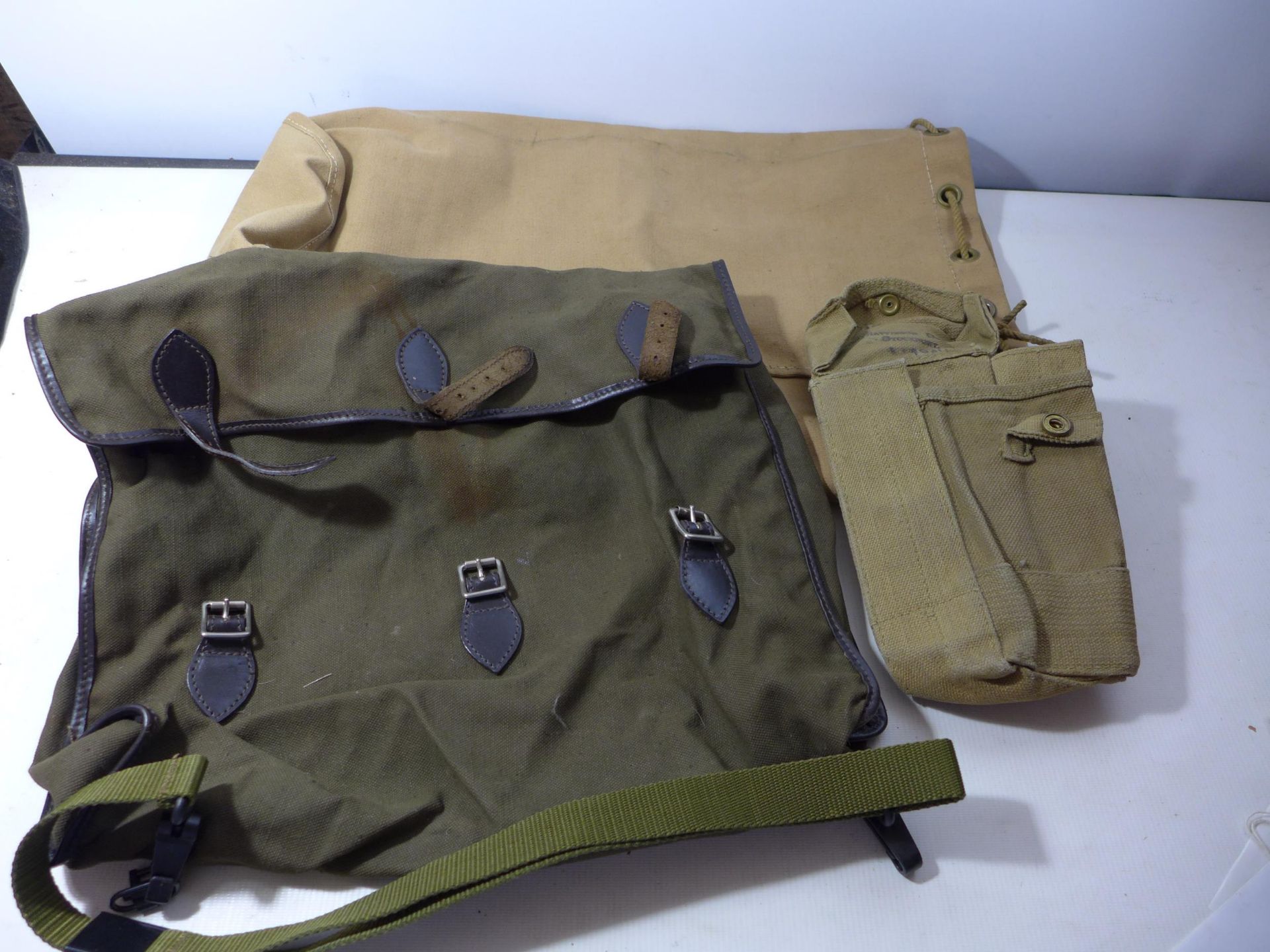 A 1940 DATED CANVAS AMMUNITION POUCH, CANVAS BAG AND A CANVAS SATCHEL (3)