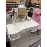 AN INVERTED BOWFRONT CREAM AND GILT DRESSING TABLE WITH TRIPLE MIRROR, 43" WIDE
