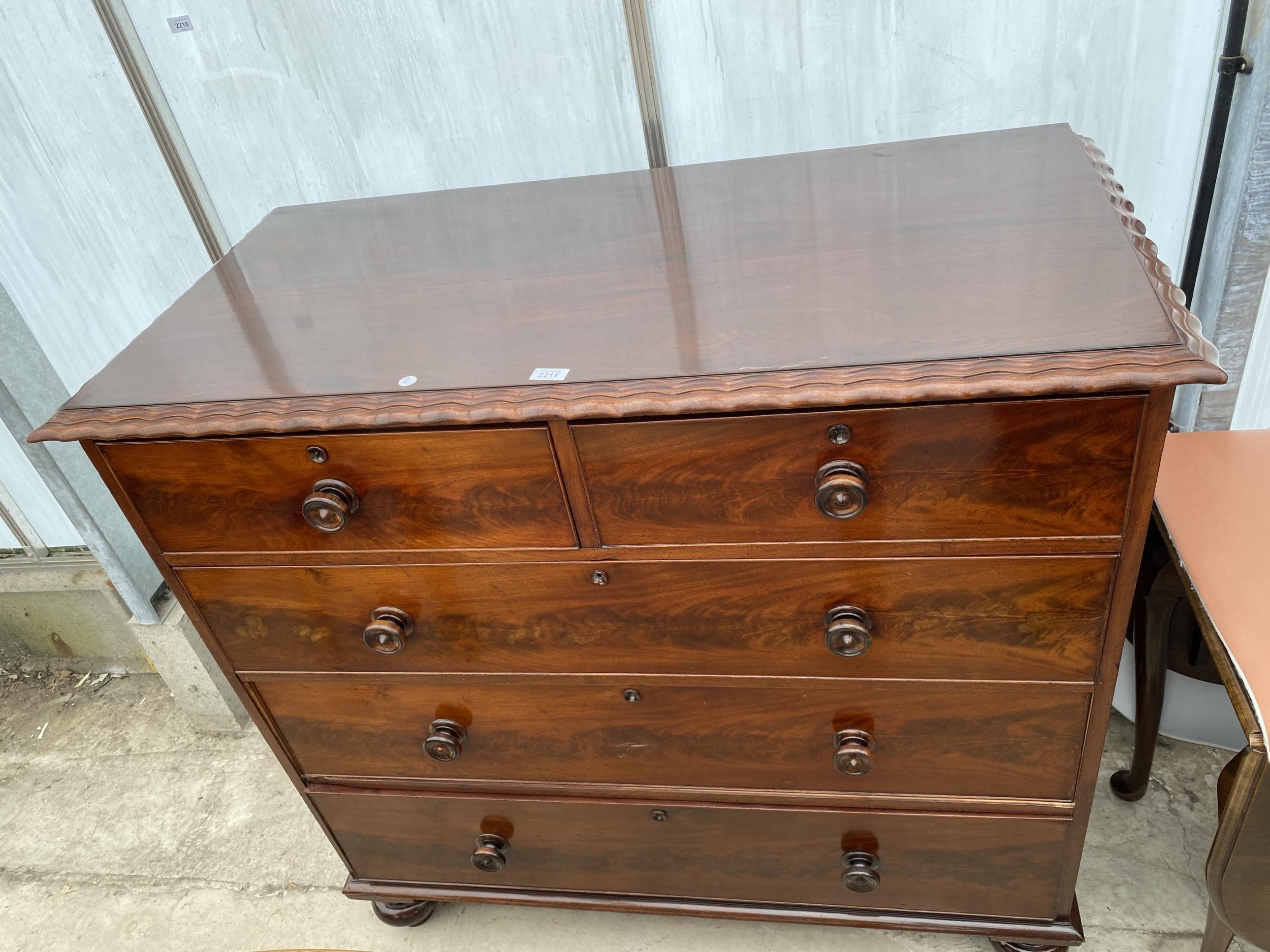 A 19TH CENTURY MAHOGANY CHEST OF TWO SHORT AND THREE LONG GRADUATED DRAWERS WITH PIE CRUST EDGE ON