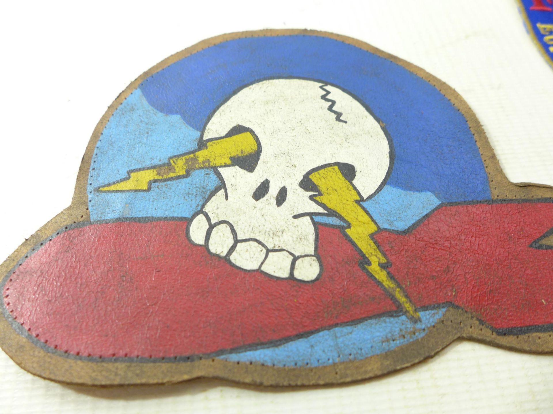 A PAINTED LEATHER PATCH WITH SKULL AND BOMB DECORATION, SHOOTING PATCH - Image 2 of 5