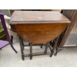 AN EARLY 20TH CENTURY OVAL OAK GATE LEG TABLE ON BARLEY TWIST LEGS 36" X 24" OPEN