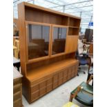 A RETRO TEAK MCINTOSH UNIT WITH GLAZED UPPER PORTION, MIRRORED PULL-DOWN SECTION AND CUPBOARDS TO