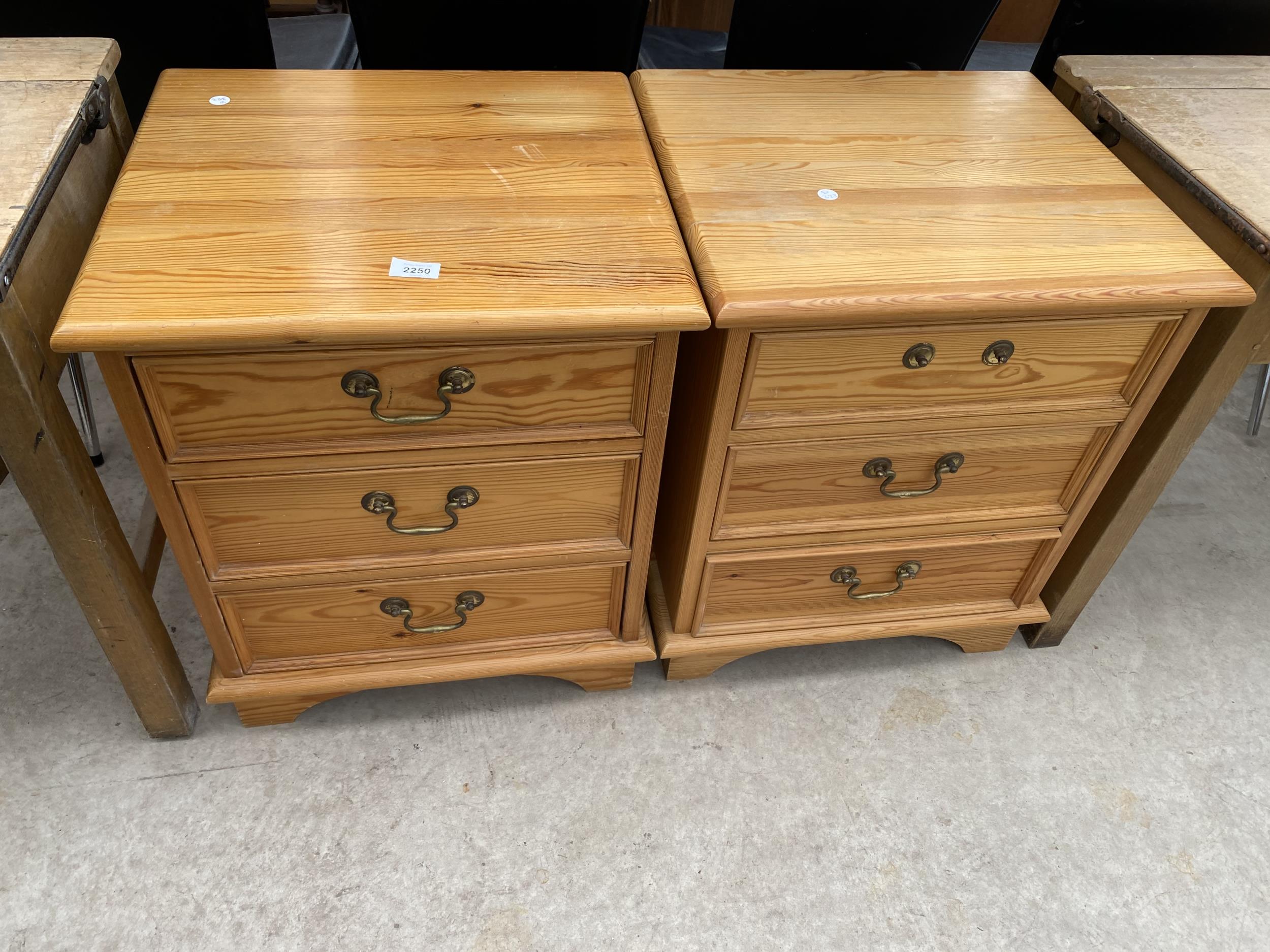 A PAIR OF MODERN PINE BEDSIDE CHESTS OF THREE DRAWERS