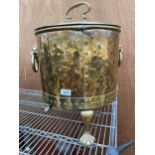 A VINTAGE BRASS COAL BUCKET WITH LION HEAD HANDLES AND LION PAW FEET