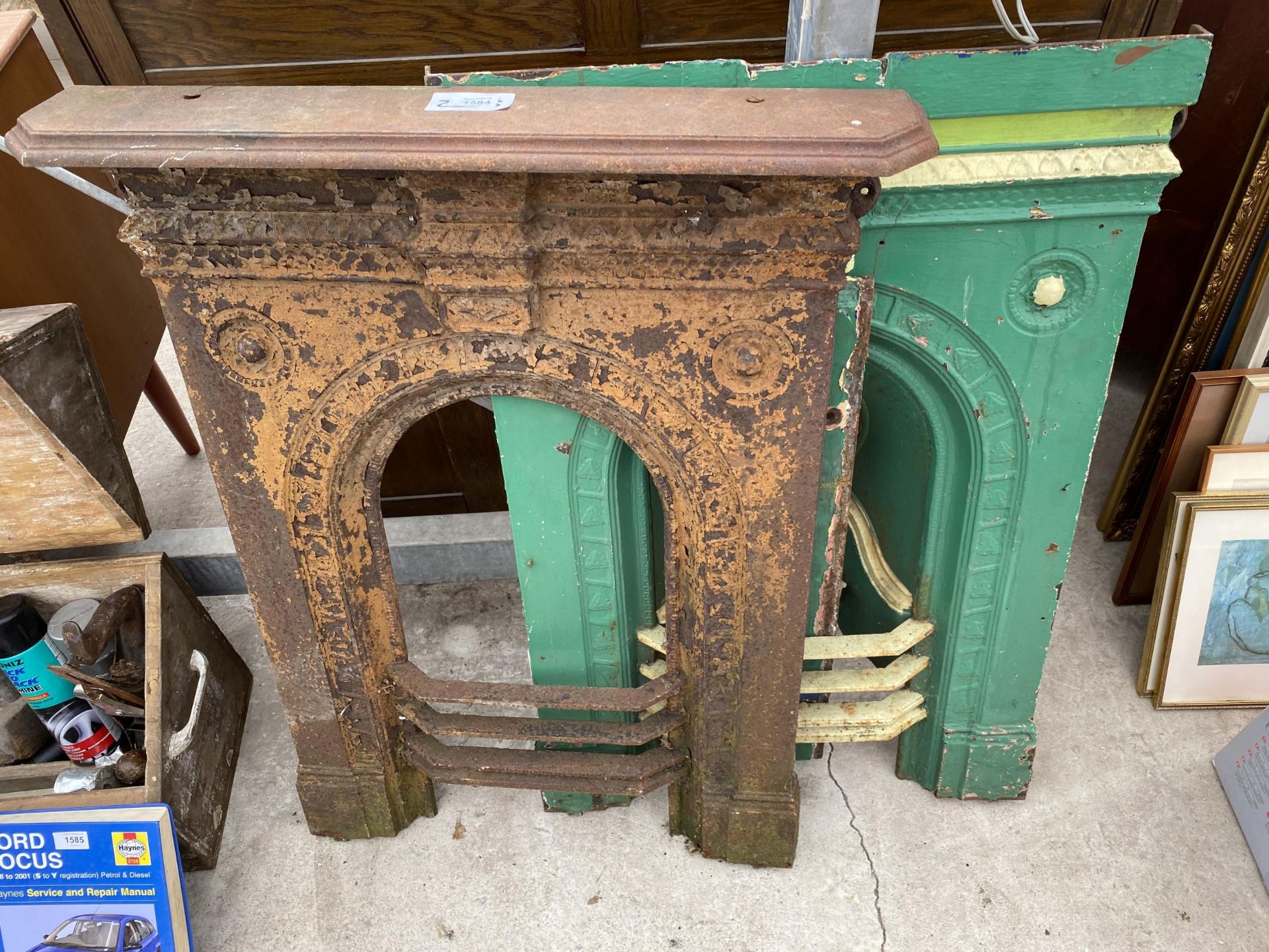 TWO VINTAGE DECORATIVE CAST IRON FIRE PLACES