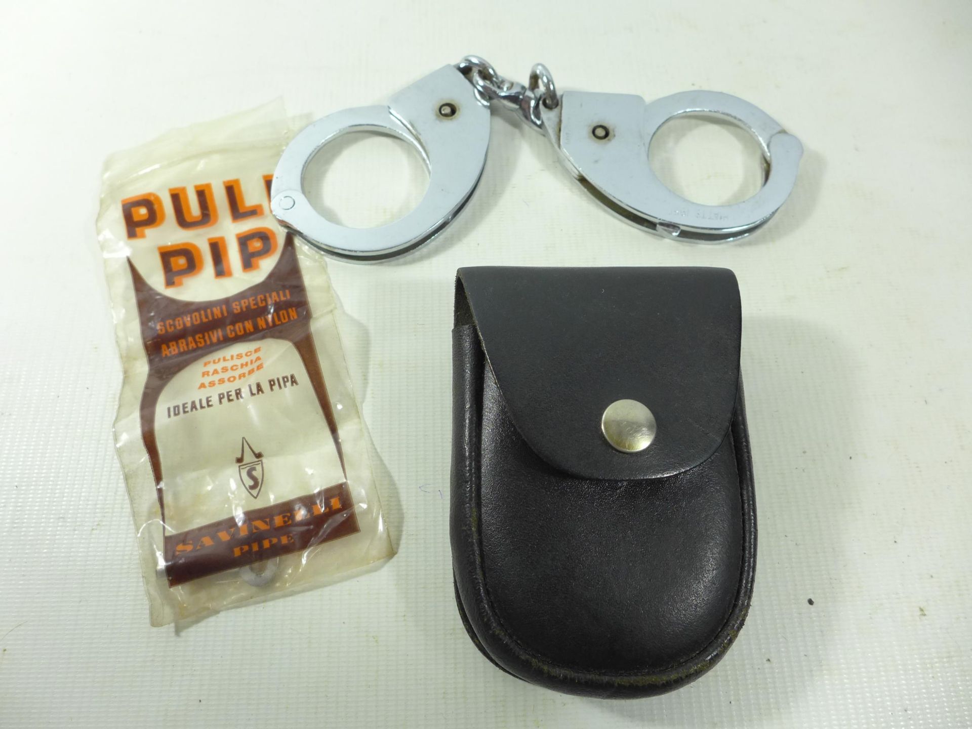 A PAIR OF HANDCUFFS, KEY AND POUCH