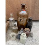 AN ASSORTMENT OF VINTAGE GLASS AND STONEWARE BOTTLES