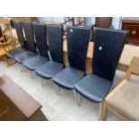 A SET OF SIX FAUX BLACK LEATHER DINING CHAIRS ON POLISHED CHROME LEGS