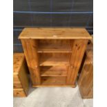 AN OPEN PINE BOOKCASE WITH END COMPARTMENTS FOR CD'S, 34" WIDE