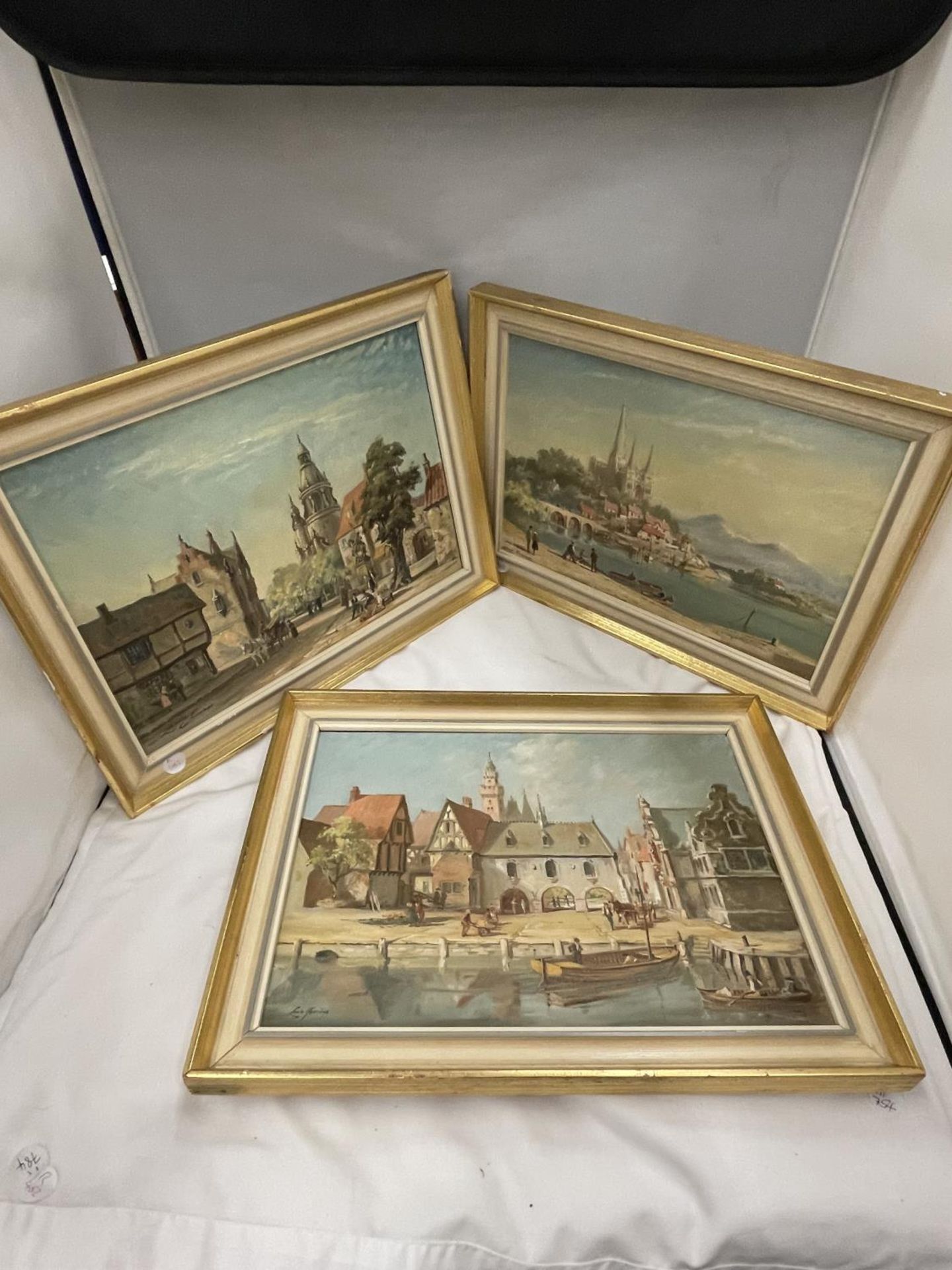 THREE FRAMED OIL ON CANVAS BY LOUIS JENNINGS, SHEFFIELD (BORN 1919) OF TOWN AND RIVER SCENES TO