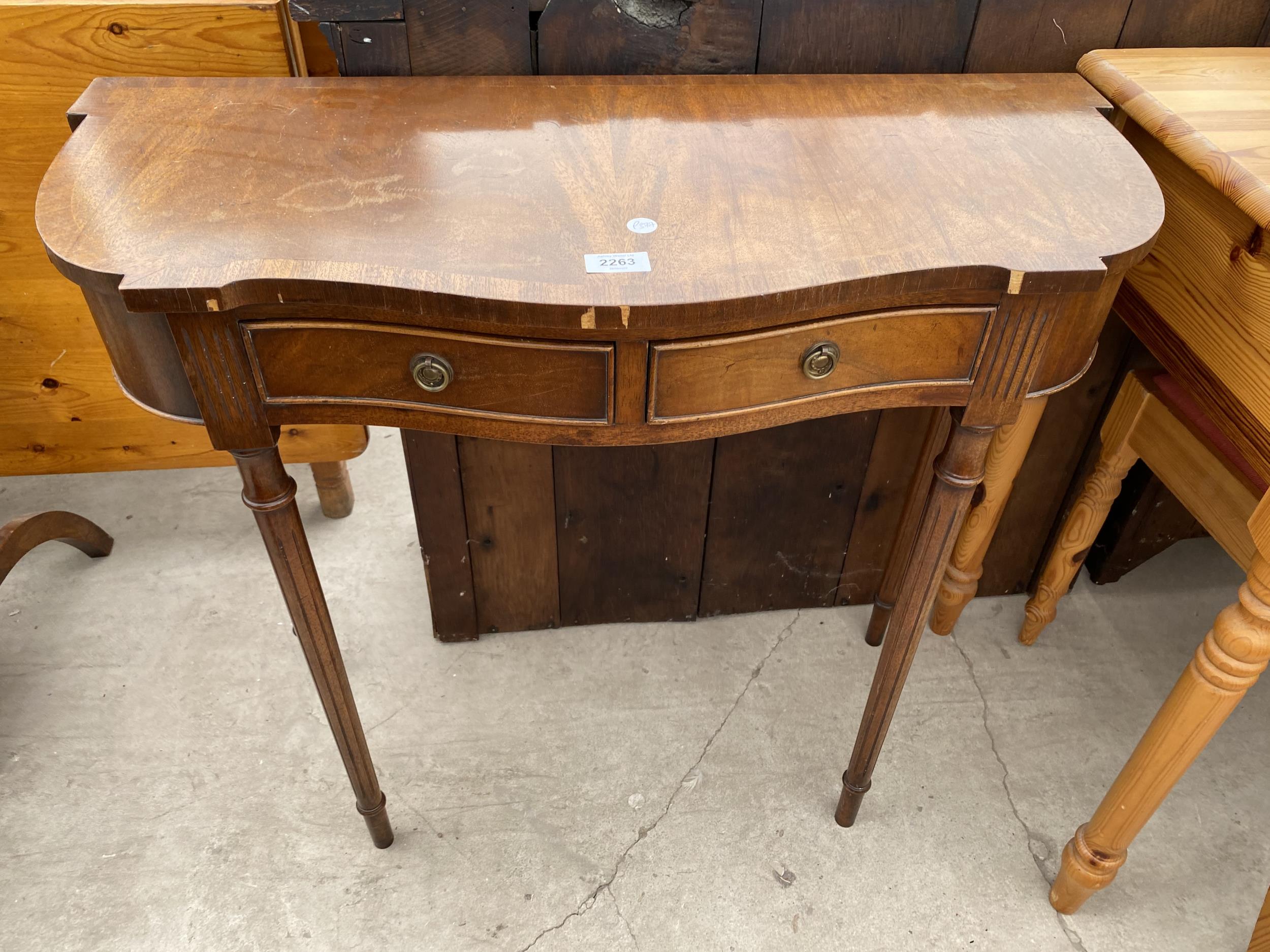 A REPRODUCTION MAHOGANY AND CROSSBAND SIDE TABLE WITH TWO DRAWERS 31" WIDE