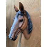 A SMALL BROWN PLASTIC HORSES HEAD