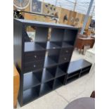 A BLACK ASH EFFECT OPEN STORAGE UNIT ENCLOSING TEN PIGEONHOLES AND FOUR DRAWERS, 44" WIDE AND LOW