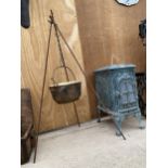 A VINTAGE CAST IRON COOKING POT WITH TRIPOD HANGING FRAME
