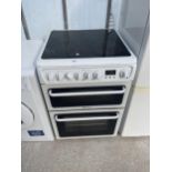 A WHITE HOTPOINT FREESTANDING ELECTRIC OVEN AND HOB