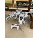 A PAIR OF REMOTE CONTROL ROBOTIC DINOSOURS