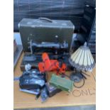 AN ASSORTMENT OF ITEMS TO INCLUDE A SINGER SEWING MACHINE, A LAMP AND A R/C CAR CONTROLLER ETC