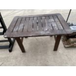 A WOODEN SLATTED GARDEN TABLE (120CM X 80CM)