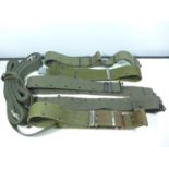 FIVE MILITARY GREEN WEBBING BELTS AND TWO SETS OF STRAPS