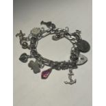 A SILVER CHARM BRACELET WITH HEART PADLOCK AND ELEVEN CHARMS