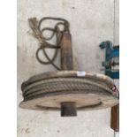 A VINTAGE WOODEN ROPE PULLEY WHEEL