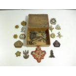 A BOER WAR PERIOD BOX CONTAINING NUMEROUS WORLD WAR I AND WORLD WAR II BADGES TO INCLUDE POLISH ARMY