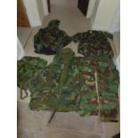 A COLLECTION OF MILITARY/SHOOTING/FISHING CAMOUFLAGE UNIFORMS AND A MILITARY RUCKSACK