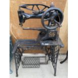 A VINTAGE INDUSTRIAL SINGER SEWING MACHINE WITH TREADLE BASE