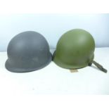 A GERMAN HELMET AND LINER AND A GREY PAINTED METAL HELMET