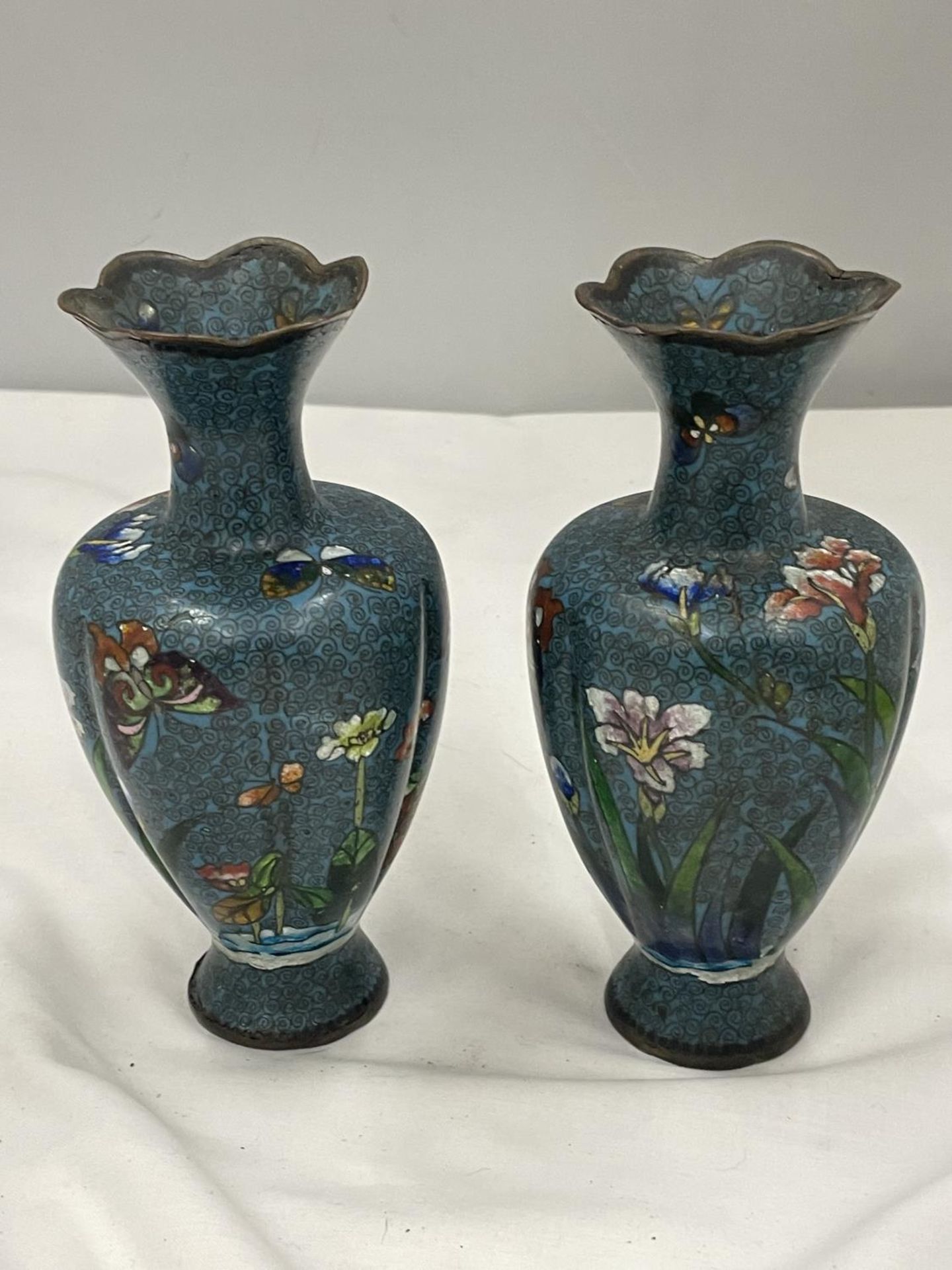 A PAIR OF CLOISONNE VASES WITH FLOWER AND BUTTERFLY DECORATION MARKED A/C 75 HEIGHT 15.5CM