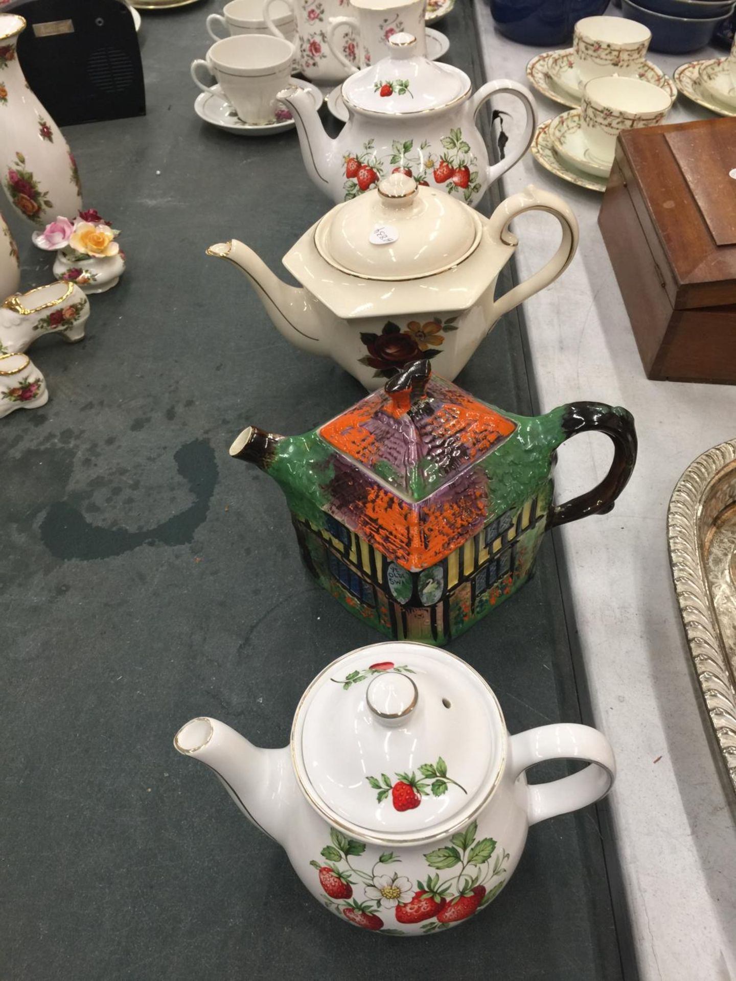 FOUR COLLECTABLE TEAPOTS TO INCLUDE SADLER STRAWBERRY, SADLER HEXAGON SHAPE, ETC