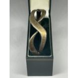 A SILVER BANGLE IN A PRESENTATION BOX