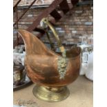 A COPPER FOOTED COAL SCUTTLE WITH BRASS HANDLE AND CERAMIC DETAIL