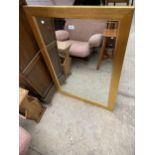 A GOLD FRAMED BEVEL EDGE MIRROR