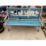 A WOODEN SLATTED CHILDREN'S BENCH WITH CAST IRON BENCH ENDS AND PLASTIC JUNGLE SCENE BACK