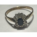 A 9 CARAT GOLD RING WITH A CENTRE SAPPHIRE SURROUNDED BY CUBIC ZIRCONIA STONES SIZE T