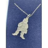 A SILVER NECKLACE WITH A LEPRECHAUN PENDANT IN A PRESENTATION BOX