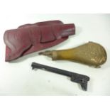 A COPPER AND BRASS POWDER FLASK, LEATHER HOLSTER AND A BLOCKED NAVY COLT BARREL (3)