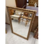 A MODERN GILT FRAMED WALL MIRROR, 38X26"