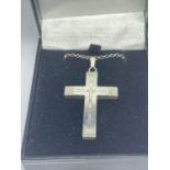 A SILVER NECKLACE WITH A CROSS PENDANT