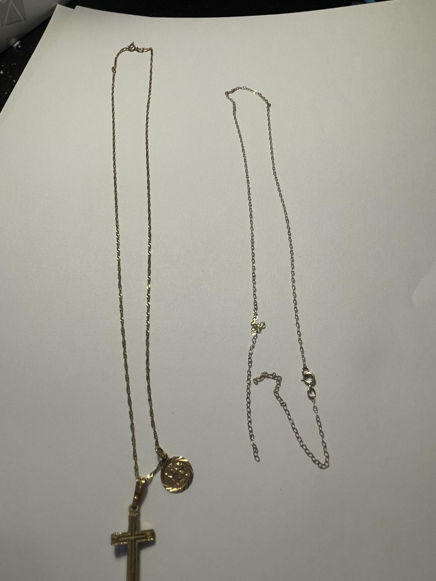 A 9 CARAT GOLD CHAIN WITH A ST CHRISTOPHER AND A CROSS PENDANT AND A FURTHER NECKLACE A/F GROSS