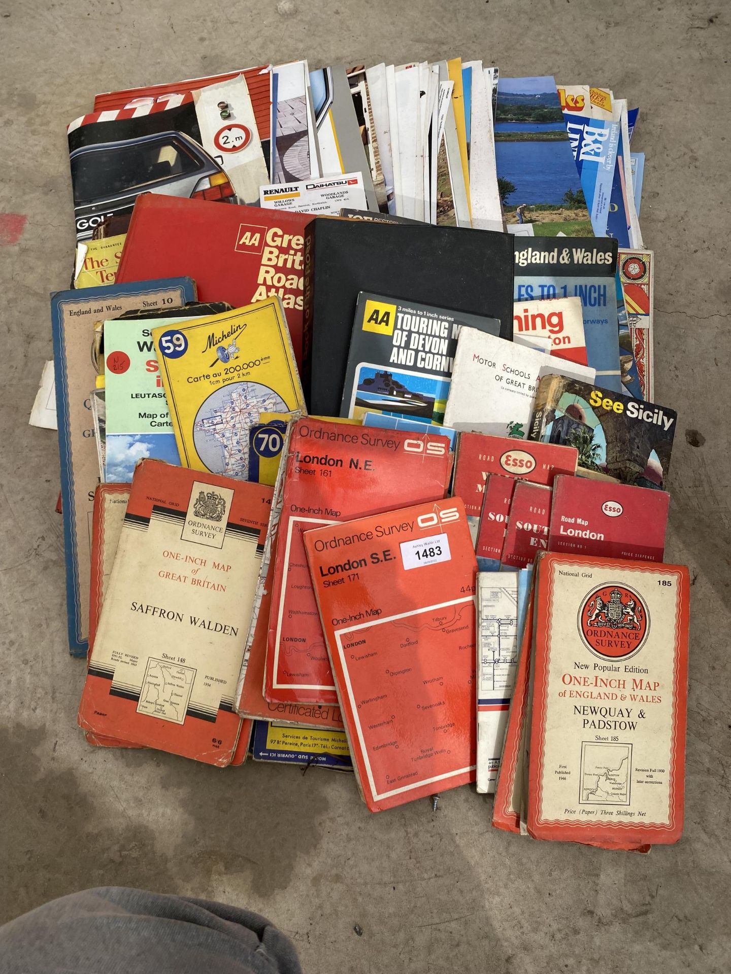 A LARGE QUANTITY OF VINTAGE CAR MANUALS AND ORDANANCE SURVEY MAPS ETC