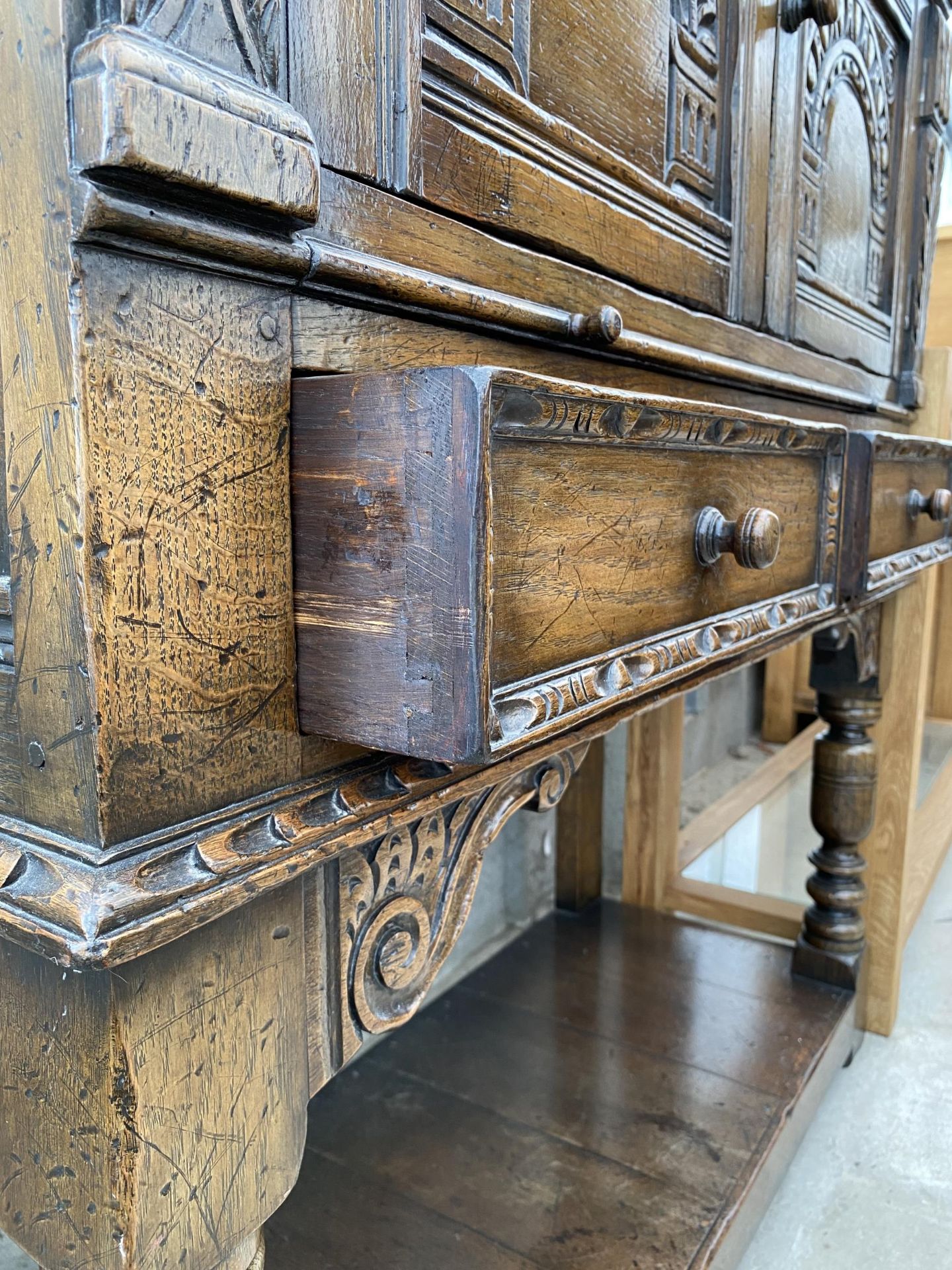 AN OAK JACOBEAN STYLE COCKTAIL CABINET WITH PANELLED DOOR, PULL OUT SLIDE, TWO DRAWERS AND A POT - Image 3 of 7