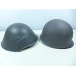 TWO GREY PAINTED METAL HELMETS AND LINERS