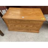 A MODERN PINE BLANKET CHEST WITH BRASS MILITARY STYLE HANDLES, 32" WIDE